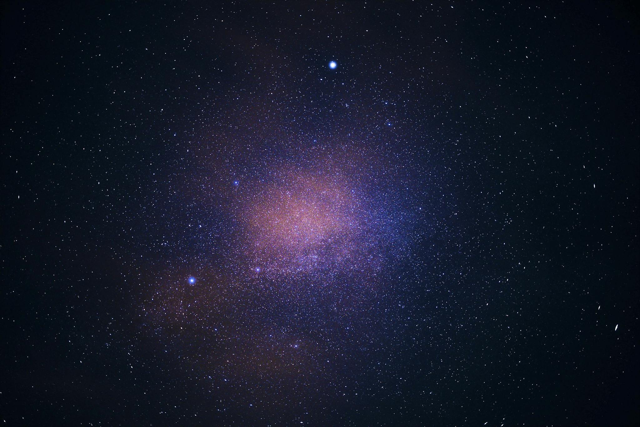 A stunning view of the galaxy cluster illuminating the starry sky, capturing the essence of the universe.