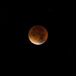 Beautiful image of a lunar eclipse, showcasing the moon's dramatic red hue against a starry sky.
